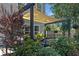 Cozy backyard patio area with pergola, hanging plants, and beautiful landscaping, perfect for relaxing and entertaining at 346 Cicadas Song, Moncks Corner, SC 29461