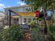 Outdoor patio area with pavers, comfortable wicker furniture and a lovely shade-providing pergola and manicured yard at 346 Cicadas Song, Moncks Corner, SC 29461
