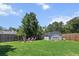 Spacious backyard with a well-maintained lawn, fire pit, and storage shed, ideal for outdoor activities and storage at 346 Cicadas Song, Moncks Corner, SC 29461