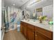 The bathroom features a double vanity, mermaid shower curtain, and tiled floors at 346 Cicadas Song, Moncks Corner, SC 29461
