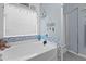 Well-lit bathroom with a large tub, coastal decor, and a separate glass-enclosed shower at 346 Cicadas Song, Moncks Corner, SC 29461
