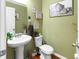 Small bathroom with pedestal sink, toilet, and decorative wall art at 346 Cicadas Song, Moncks Corner, SC 29461