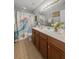 The bathroom features a double vanity, mermaid shower curtain, and tiled floors at 346 Cicadas Song, Moncks Corner, SC 29461
