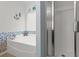 Bright bathroom featuring a tub with blue tile accents and a glass-enclosed shower at 346 Cicadas Song, Moncks Corner, SC 29461