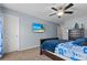 The stylish bedroom showcases a TV, ceiling fan, nautical-themed decor and blue accents at 346 Cicadas Song, Moncks Corner, SC 29461