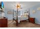 A charming bedroom featuring a four-poster bed, ceiling fan and nautical decor at 346 Cicadas Song, Moncks Corner, SC 29461