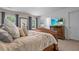 Bedroom features a decorative bed, TV, and natural light from windows at 346 Cicadas Song, Moncks Corner, SC 29461