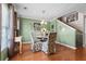 Dining area with hardwood floors, elegant chairs, chandelier, and adjacent staircase at 346 Cicadas Song, Moncks Corner, SC 29461