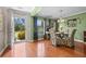 Dining room with hardwood floors, green walls, large windows, and a decorative dining set at 346 Cicadas Song, Moncks Corner, SC 29461