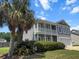 Charming two-story home with a double porch, manicured lawn, and palm tree at 346 Cicadas Song, Moncks Corner, SC 29461