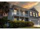 Charming two-story home with a double porch and a manicured lawn at 346 Cicadas Song, Moncks Corner, SC 29461