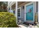 Charming home entryway with a teal door, decorative lanterns, and a welcoming aesthetic at 346 Cicadas Song, Moncks Corner, SC 29461