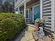 Inviting front porch decorated with beautiful flowers and decor at 346 Cicadas Song, Moncks Corner, SC 29461