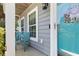 Inviting front porch featuring a teal door, cozy seating, and a well-maintained exterior at 346 Cicadas Song, Moncks Corner, SC 29461
