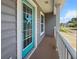 Front porch featuring a blue door with star decoration and wood floors at 346 Cicadas Song, Moncks Corner, SC 29461