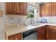 Bright kitchen with a stainless steel double sink, wood cabinets, and view from the window at 346 Cicadas Song, Moncks Corner, SC 29461