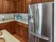 Kitchen with stainless steel refrigerator, wood cabinets, and tile backsplash at 346 Cicadas Song, Moncks Corner, SC 29461