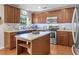 Kitchen featuring stainless steel appliances, wood cabinets, and a modern backsplash at 346 Cicadas Song, Moncks Corner, SC 29461