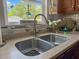 Kitchen features stainless steel sink, faucet, countertop, and view from the window at 346 Cicadas Song, Moncks Corner, SC 29461
