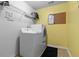 Laundry room with washing machine, dryer, storage shelf and black rug at 346 Cicadas Song, Moncks Corner, SC 29461