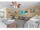 Cozy living room featuring a decorative ceiling fan, fireplace, and comfortable seating at 346 Cicadas Song, Moncks Corner, SC 29461