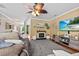 Spacious living room with fireplace, media console, and open access to foyer and dining area at 346 Cicadas Song, Moncks Corner, SC 29461