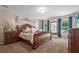 Main bedroom boasts a decorative bed frame, window seat, and elegant lighting at 346 Cicadas Song, Moncks Corner, SC 29461