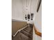 Descending carpeted stairway with decorative wall art, lit by a modern chandelier at 346 Cicadas Song, Moncks Corner, SC 29461