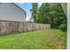 Fenced backyard with a lush lawn, providing privacy and a safe area for outdoor activities and relaxation at 3639 Pimmit Pl, Ladson, SC 29456