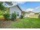 Backyard featuring a well-maintained lawn, covered patio, and tastefully selected bushes at 3639 Pimmit Pl, Ladson, SC 29456