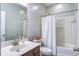 Bright bathroom featuring a shower-tub combo, vanity with sink, and a white shower curtain at 3639 Pimmit Pl, Ladson, SC 29456