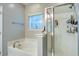Bathroom featuring a separate tub and enclosed shower, tile flooring and a window at 3639 Pimmit Pl, Ladson, SC 29456