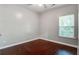 Cozy bedroom features hardwood floors, neutral paint, and natural light from the window at 3639 Pimmit Pl, Ladson, SC 29456
