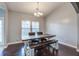 Well-lit dining room featuring a rustic table, comfortable seating, and a modern chandelier at 3639 Pimmit Pl, Ladson, SC 29456