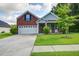 Charming two-story home with a brick facade, well-manicured lawn, and a spacious two-car garage at 3639 Pimmit Pl, Ladson, SC 29456