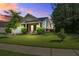 Charming front yard at dusk featuring a well-manicured lawn, covered porch, and welcoming facade at 3639 Pimmit Pl, Ladson, SC 29456