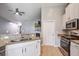 Open concept kitchen featuring white cabinets, stainless appliances, granite countertops and tile flooring at 3639 Pimmit Pl, Ladson, SC 29456