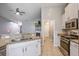 Open concept kitchen featuring white cabinets, stainless appliances, granite countertops and tile flooring at 3639 Pimmit Pl, Ladson, SC 29456