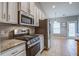 Bright kitchen featuring white cabinets, stainless appliances, granite countertops, tile backsplash and breakfast nook at 3639 Pimmit Pl, Ladson, SC 29456