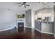 Comfortable living room with a fireplace, TV, and view into the modern kitchen, all with hardwood floors at 3639 Pimmit Pl, Ladson, SC 29456