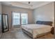 A neutral bedroom featuring a window, tray ceiling, carpet, and a mirror at 3639 Pimmit Pl, Ladson, SC 29456