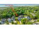 Aerial view showing this home's placement in a serene neighborhood with mature trees and proximity to the waterfront at 3711 Tip Ln, Mount Pleasant, SC 29466