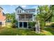 Charming blue home featuring a screened porch, landscaped yard, and convenient staircase access at 3711 Tip Ln, Mount Pleasant, SC 29466