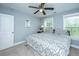 Comfortable bedroom featuring carpet, ceiling fan, and plenty of natural light from two windows at 3711 Tip Ln, Mount Pleasant, SC 29466