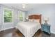 Relaxing bedroom featuring hardwood floors, a ceiling fan, and windows with natural light at 3711 Tip Ln, Mount Pleasant, SC 29466