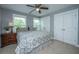 Cozy bedroom with two windows, ceiling fan, neutral carpet, and closet with double doors at 3711 Tip Ln, Mount Pleasant, SC 29466