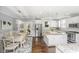 Bright dining room featuring beautiful dark hardwood flooring and access to the kitchen and patio at 3711 Tip Ln, Mount Pleasant, SC 29466