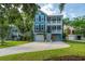 Two story home with double porches, attached garages, colorful flowers, and a well maintained lawn at 3711 Tip Ln, Mount Pleasant, SC 29466