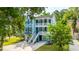 Charming blue two-story home featuring double balconies, a well-manicured lawn, and a paved driveway at 3711 Tip Ln, Mount Pleasant, SC 29466