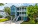 Charming blue two-story home featuring double balconies, a well-manicured lawn, and a paved driveway at 3711 Tip Ln, Mount Pleasant, SC 29466
